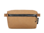 Brown toiletry bag with black zipper on a white background