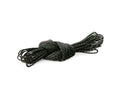 Coiled black rope with green specks on a white background