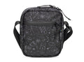 Black crossbody bag with white geometric patterns on a white background