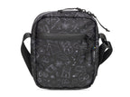 Black crossbody bag with white geometric patterns on a white background