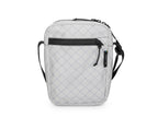 Quilted gray crossbody bag with black accents on a white background