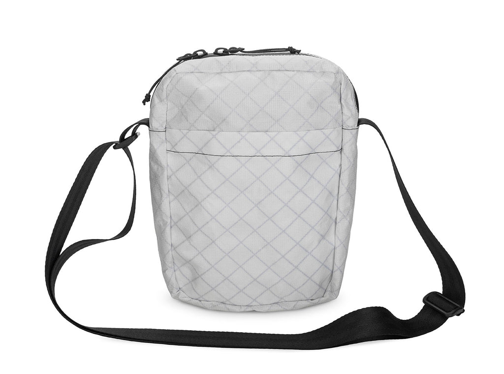 Quilted gray crossbody bag on a white background
